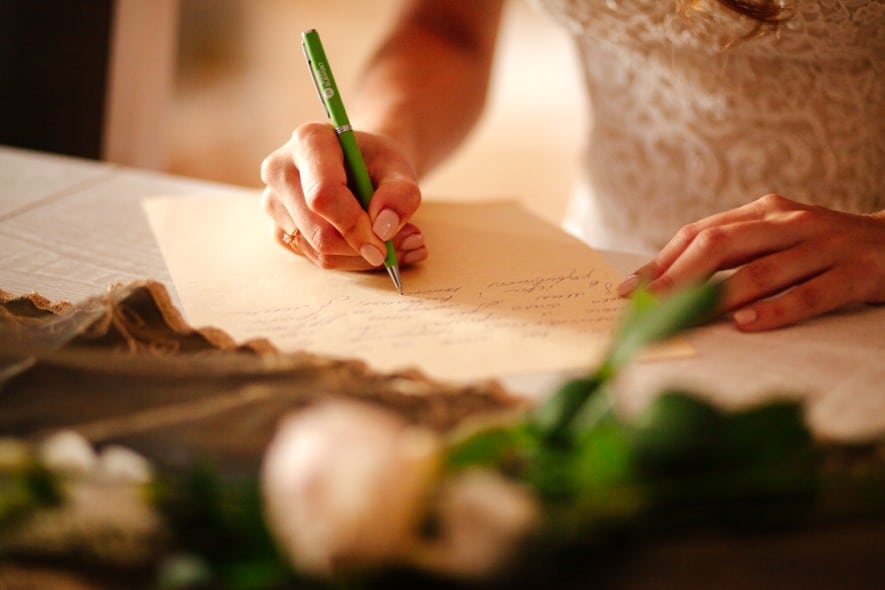 bride writing vows for wedding