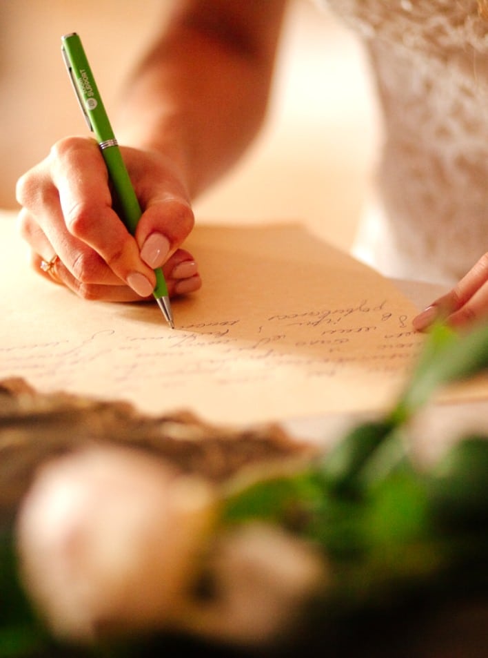 bride writing vows for wedding